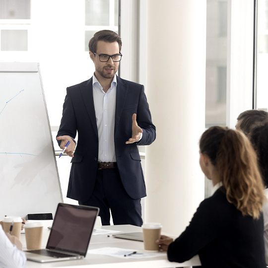 Man giving a presentation in front of white board